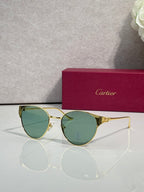 Cartier glasses with gold-tone round frames and green tinted lenses