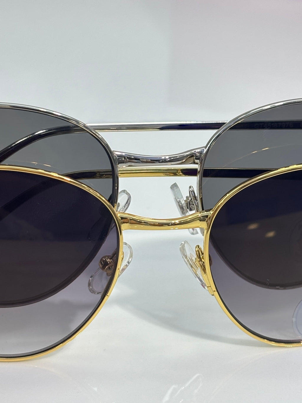 Cartier glasses close-up: round dark-tinted lenses with gold and silver-tone frames