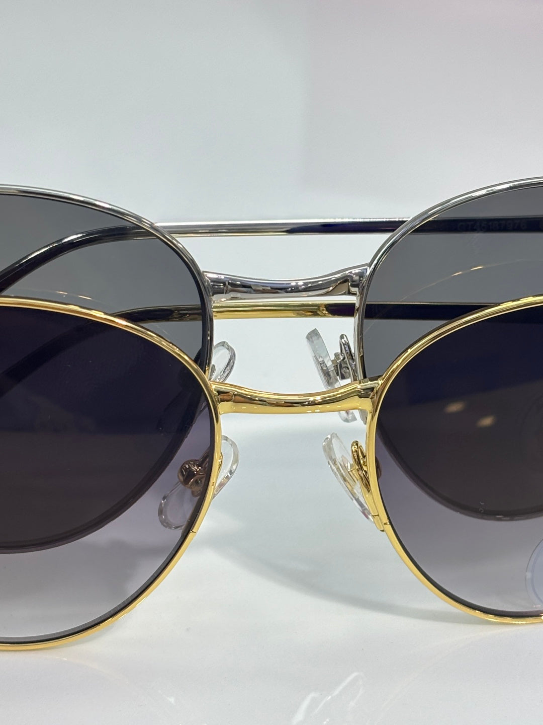 Cartier glasses close-up: round dark-tinted lenses with gold and silver-tone frames