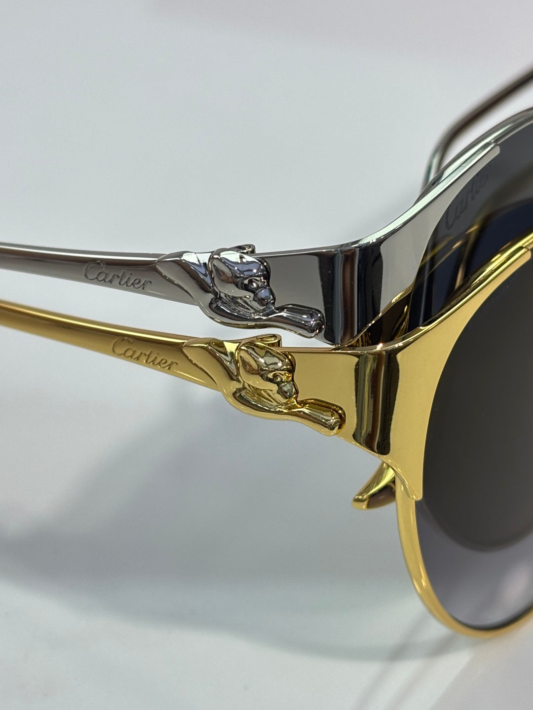 Cartier glasses close-up: gold-tone temple with ornate crest detail
