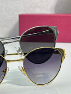 Cartier glasses close-up: gold-tone frame with purple tinted lens and hinge