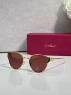 Cartier glasses with gold-tone round frames and burgundy tinted lenses