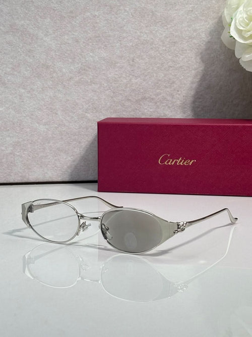 Cartier eyeglasses with round silver frame and tinted clear lenses