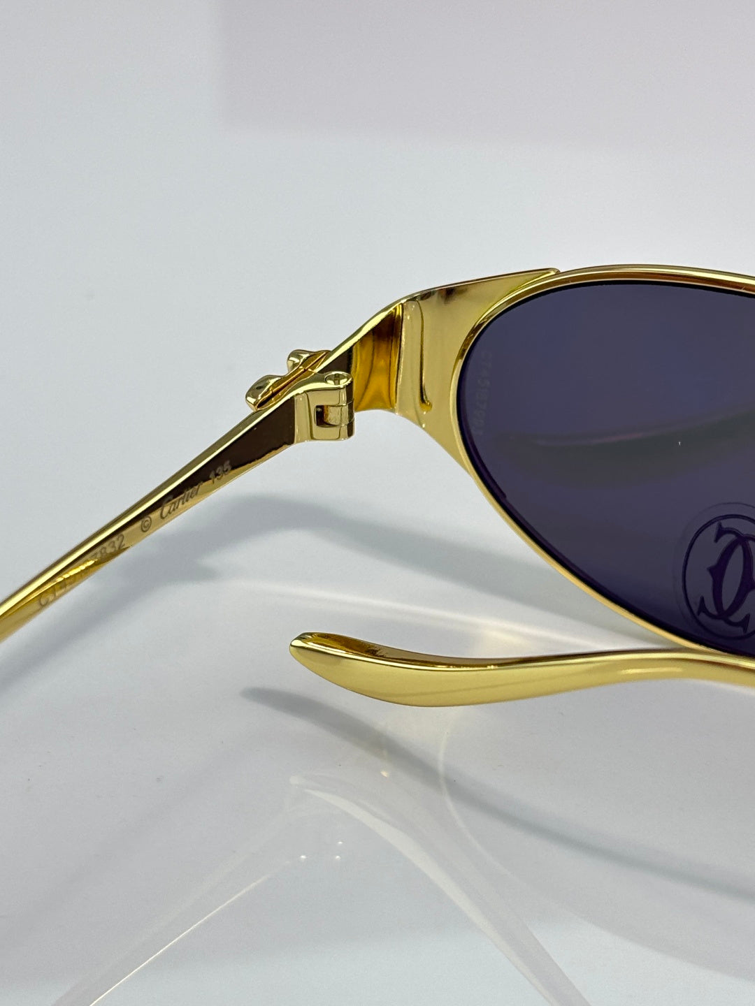 Gold eyeglasses with angled temple and dark gradient lenses