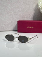 Cartier sunglasses with silver frames and dark round lenses