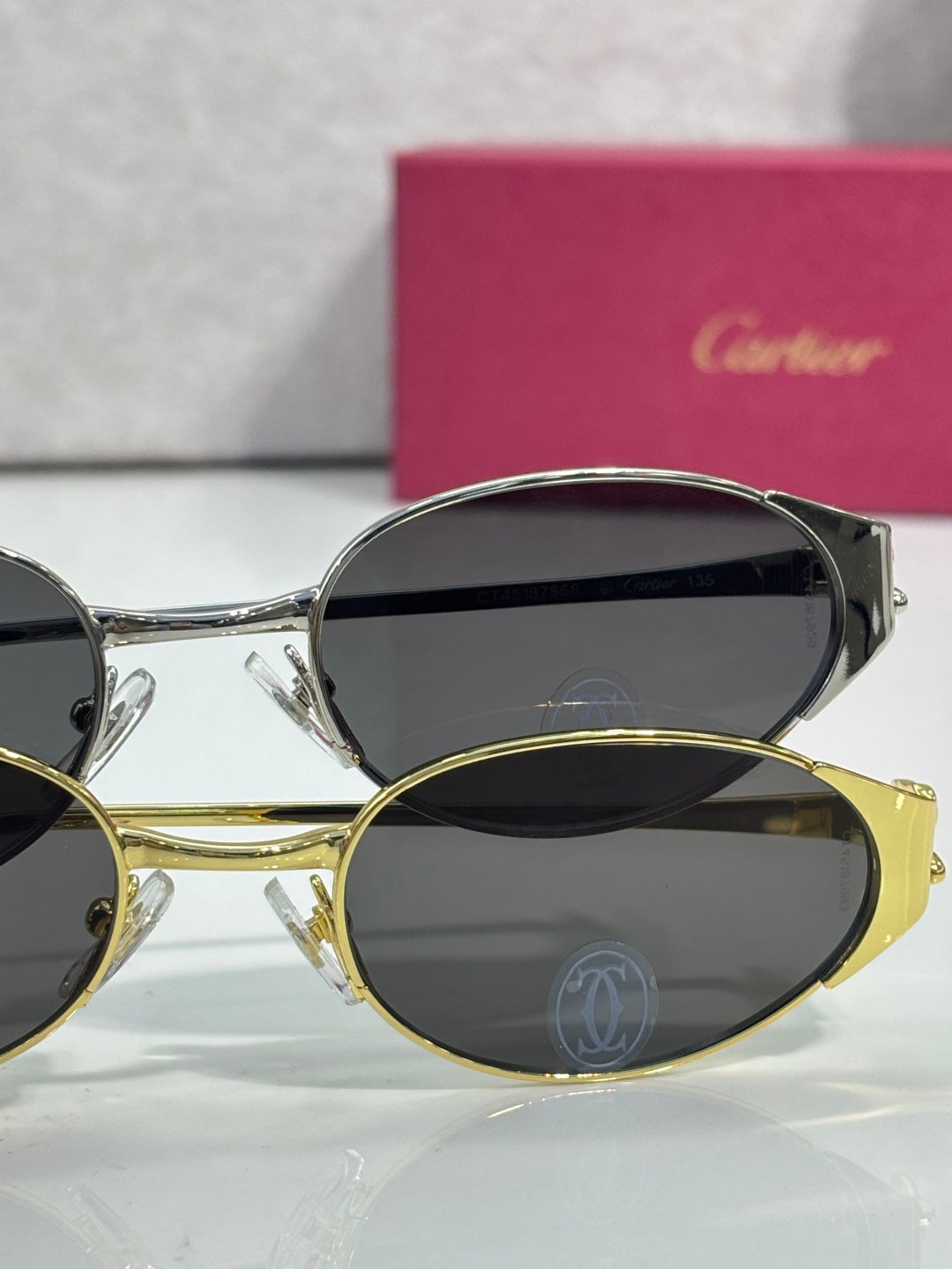 Cartier sunglasses with mixed silver and gold frames and dark lenses