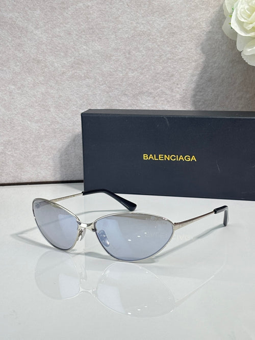 Cat-eye sunglasses with thin metal frame, black temples, blue-tinted lenses