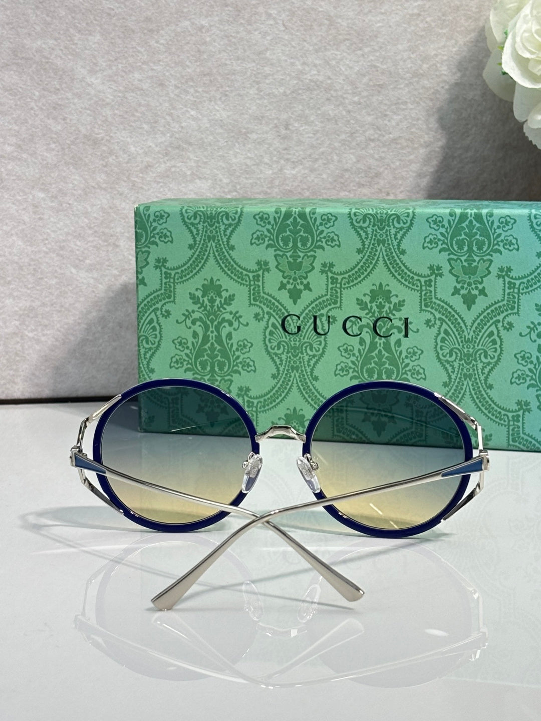 Round eyeglasses with dark blue frames and yellow-tinted round lenses