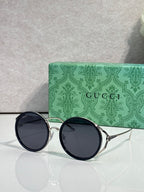 Round eyeglasses with silver metal frames and dark round tinted lenses