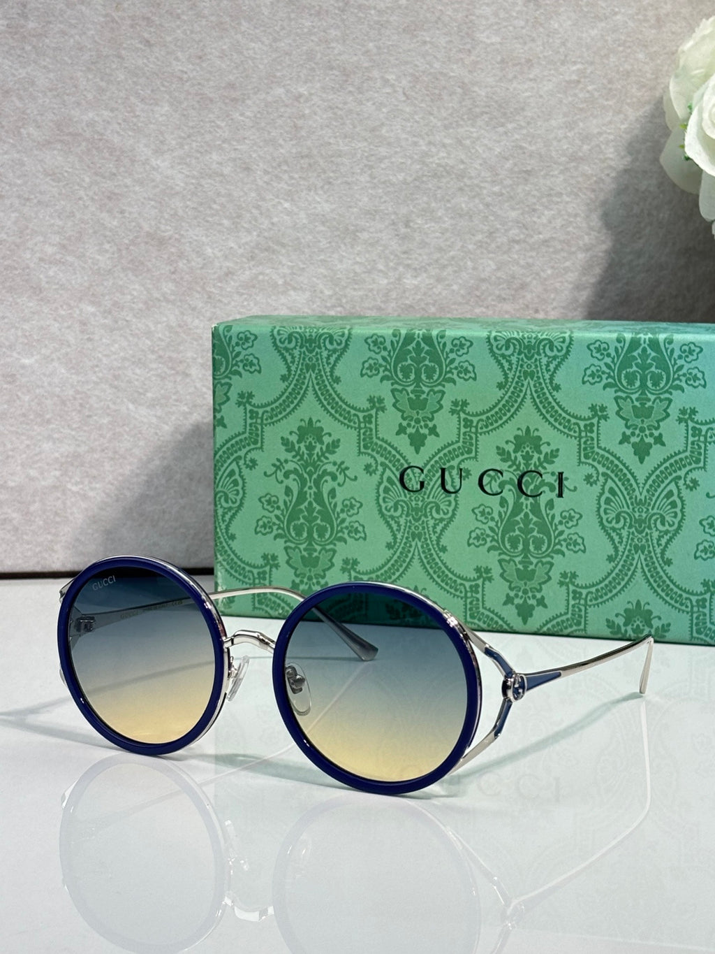 Round eyeglasses with dark blue frames and yellow-tinted lenses