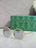 Gucci round eyeglasses with gold metal frames and light blue tinted lenses