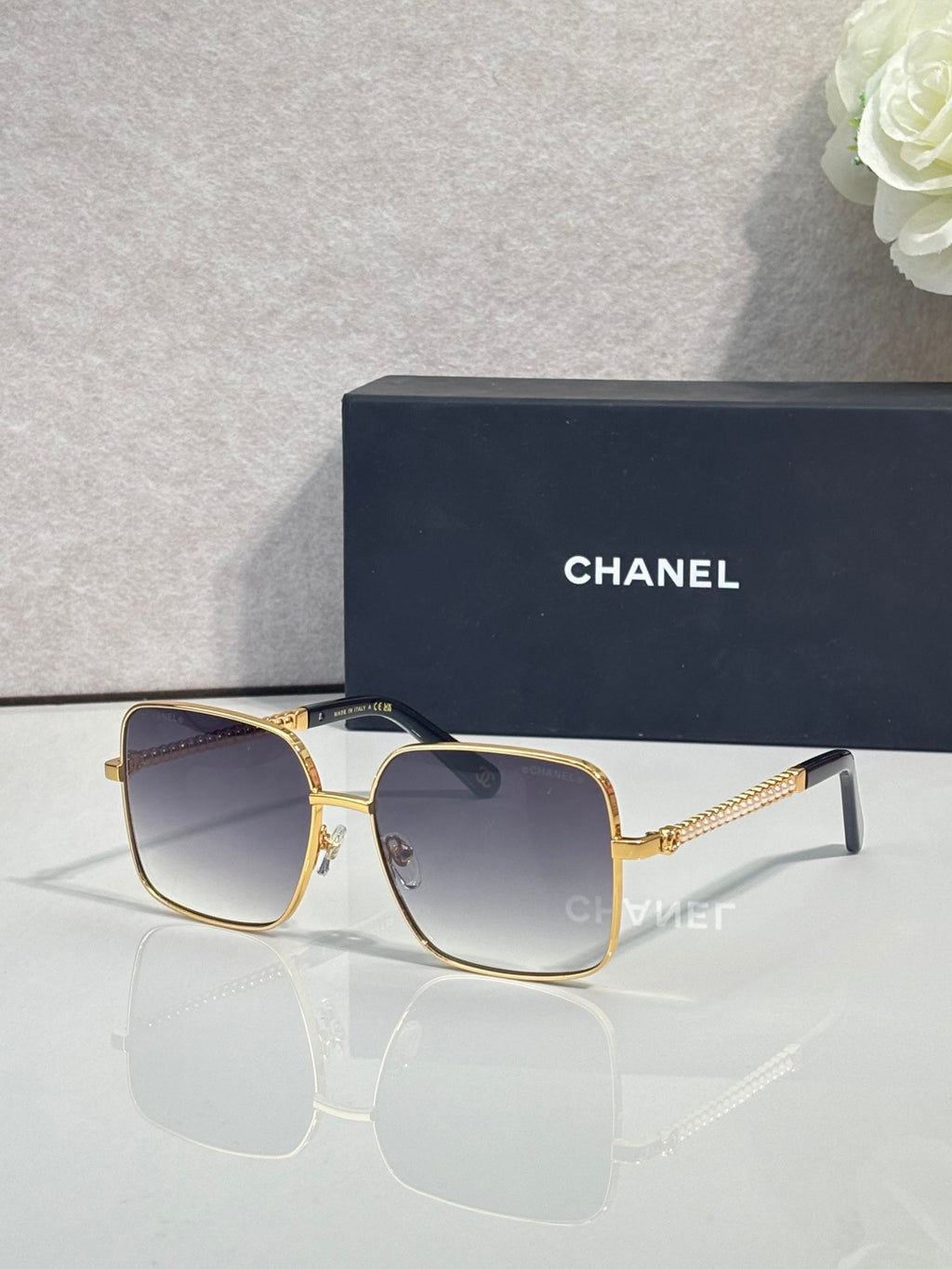 CHANEL square sunglasses with gold frames and dark gradient lenses
