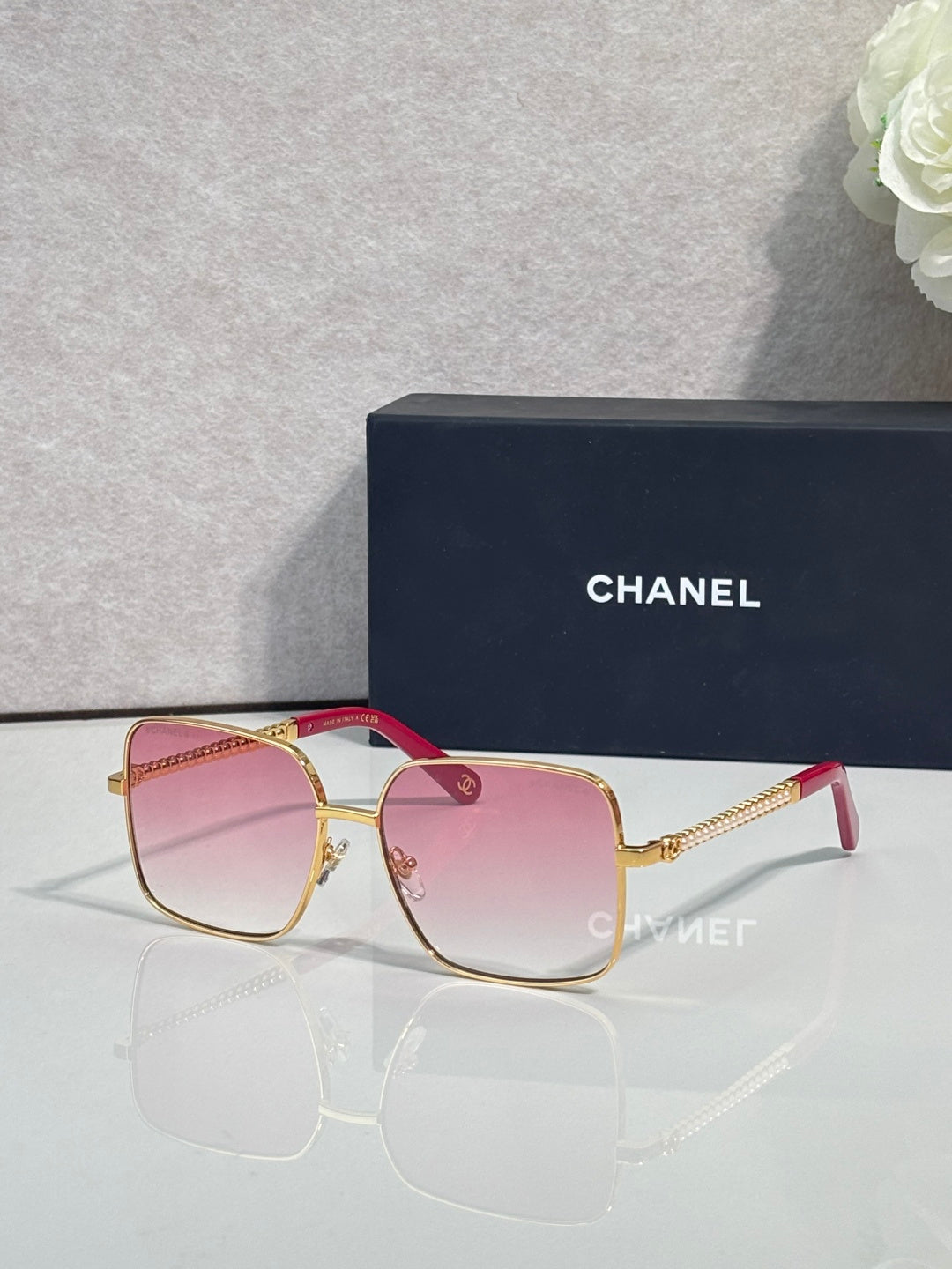 CHANEL square sunglasses with gold frames and pink gradient lenses
