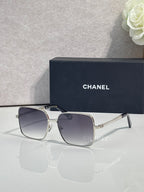 CHANEL square sunglasses with silver frames and blue gradient lenses