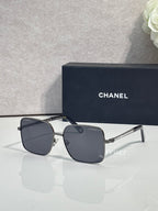 CHANEL square sunglasses with dark frames and smoky lenses
