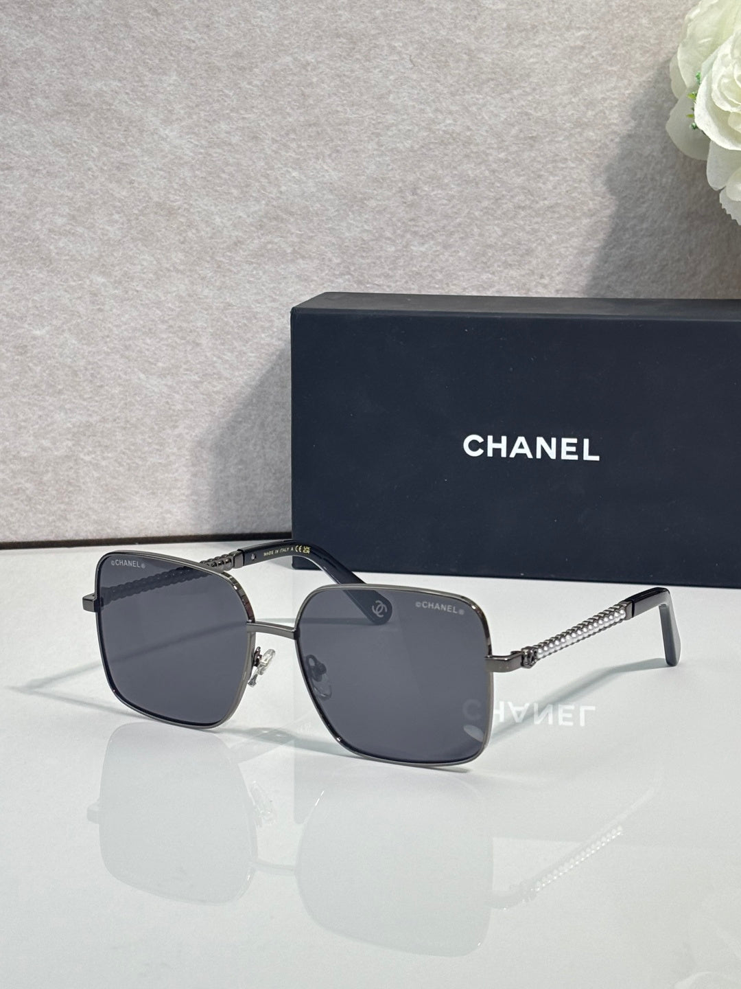 CHANEL square sunglasses with dark frames and smoky lenses