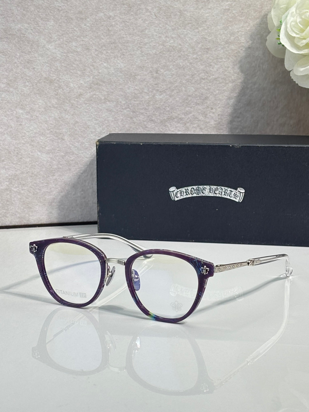 Navy round eyeglasses with purple-accent temple arms and clear lenses