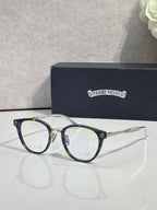 Navy round eyeglasses with gold-tone metal accents and clear lenses