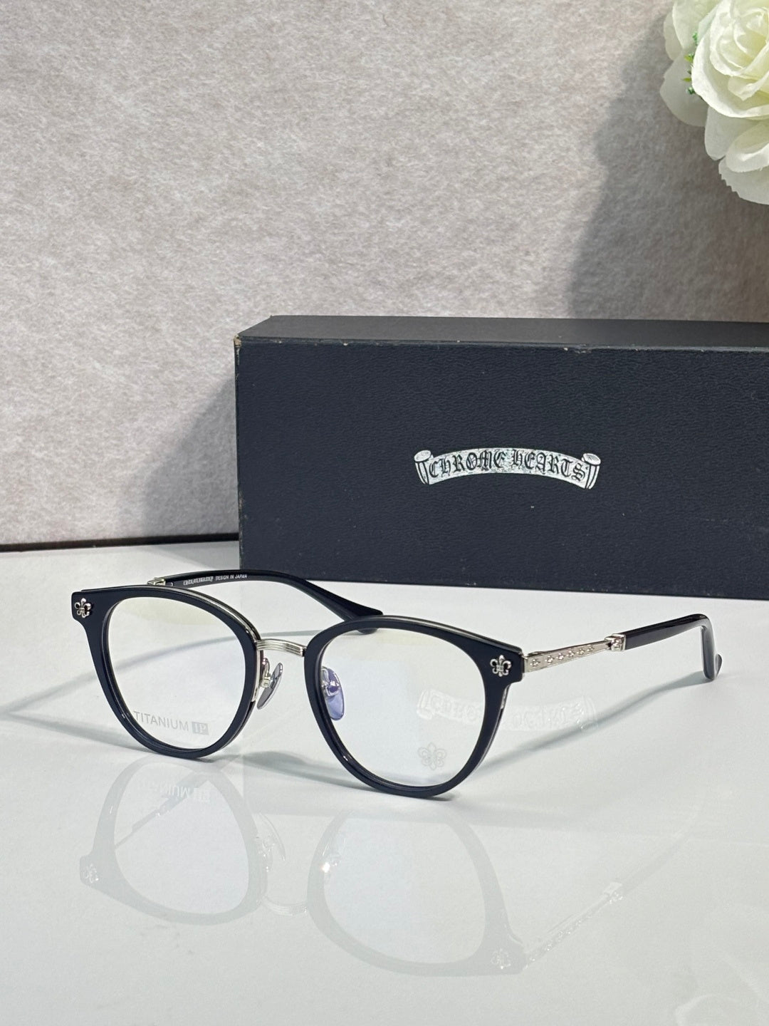 Dark navy round eyeglasses with thin metal arms and clear lenses