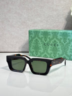 Black rectangular sunglasses with dark green lenses and Gucci logo on side arms.