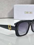 Black Dior sunglasses, side view with gold D logo on the arm.