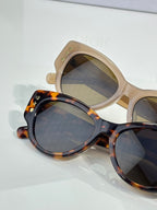 Two Dior cat-eye sunglasses, beige and tortoiseshell, with tinted lenses