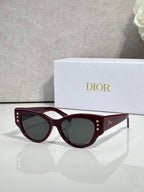 Dior burgundy cat-eye sunglasses with dark lenses and gold accents