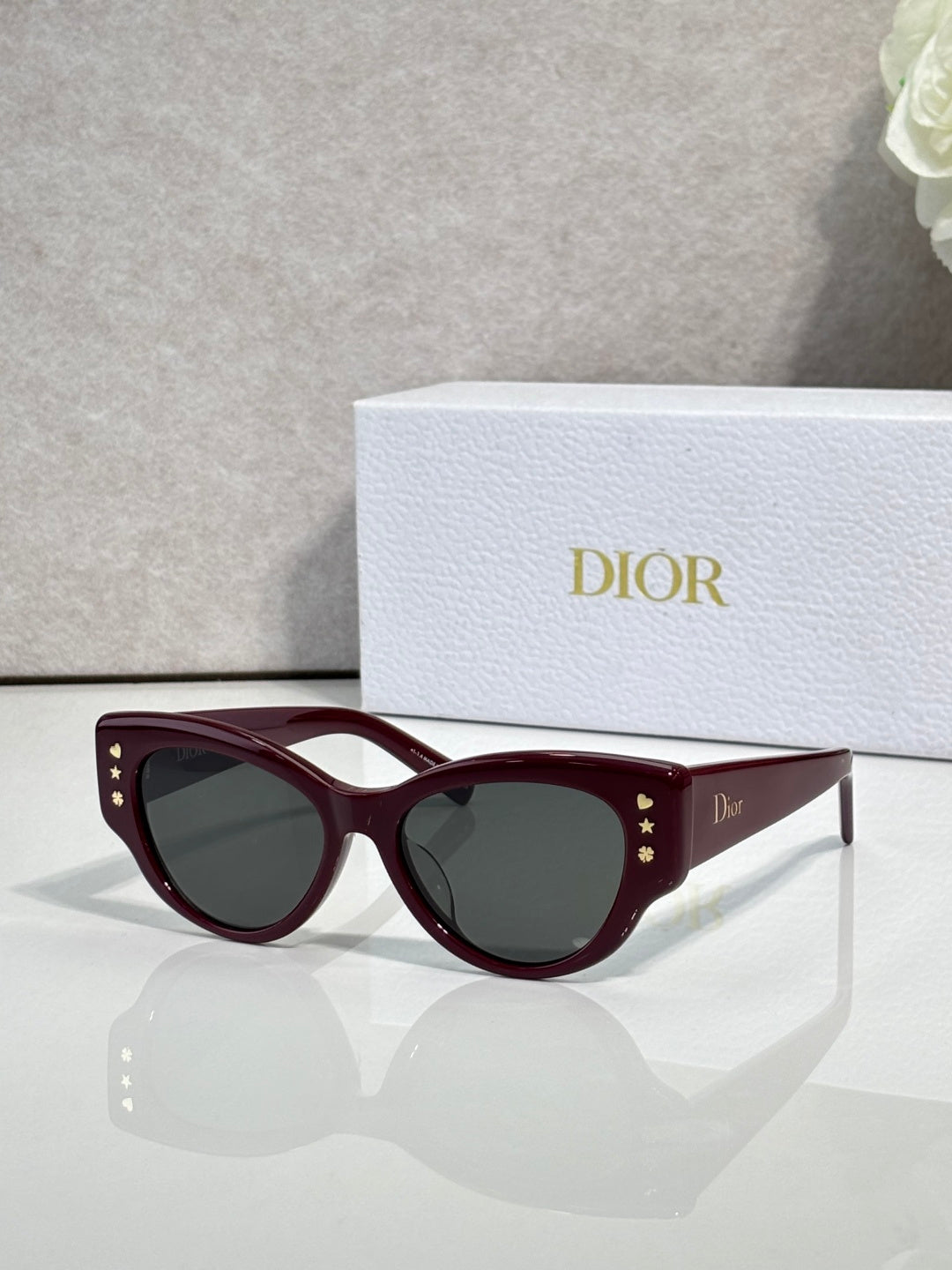 Dior burgundy cat-eye sunglasses with dark lenses and gold accents