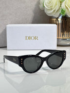 Dior black cat-eye sunglasses with dark lenses and gold logo details