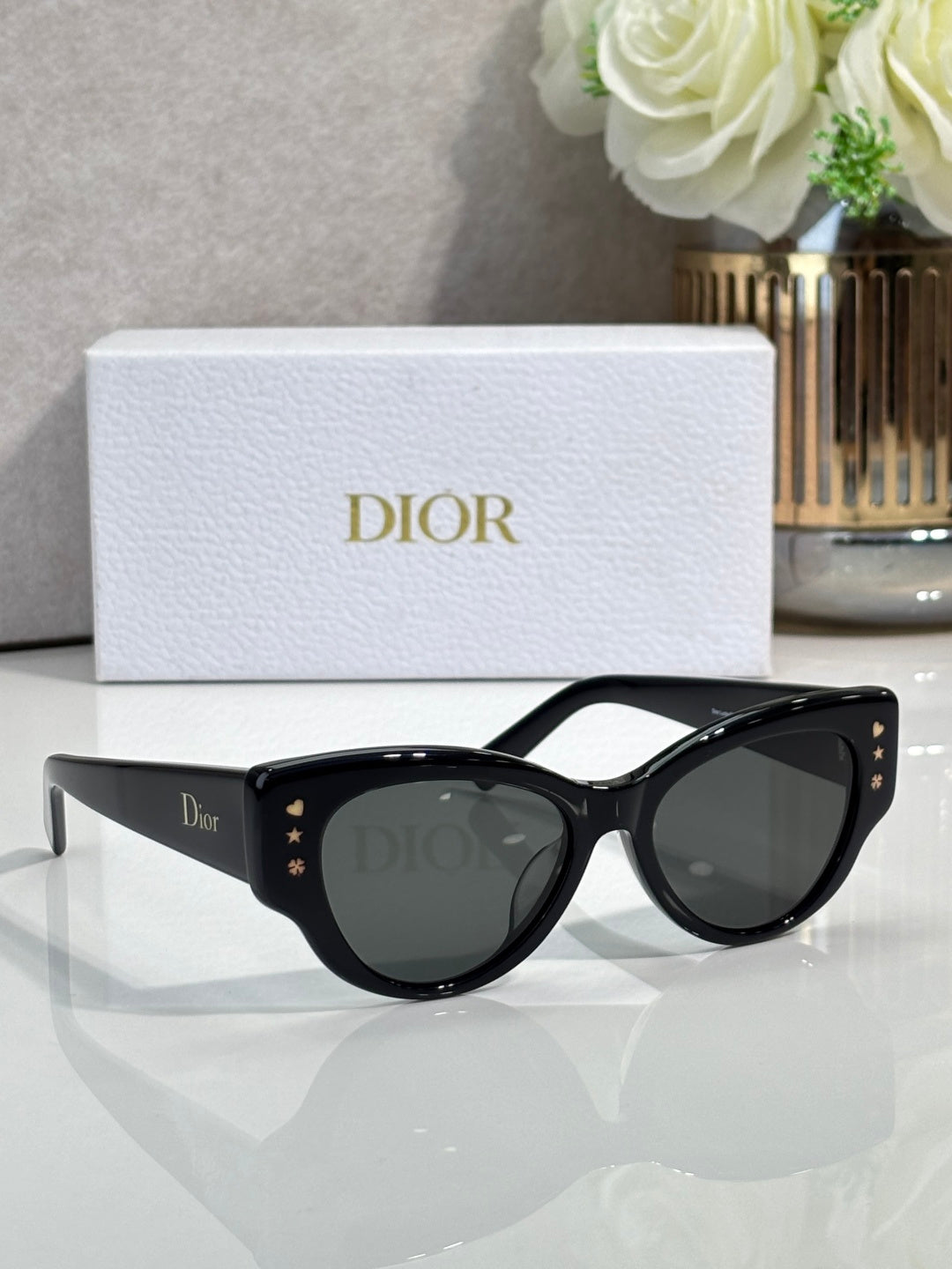 Dior black cat-eye sunglasses with dark lenses and gold logo details