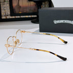 Gold metal eyeglasses with clear lenses and tortoise-pattern temple tips