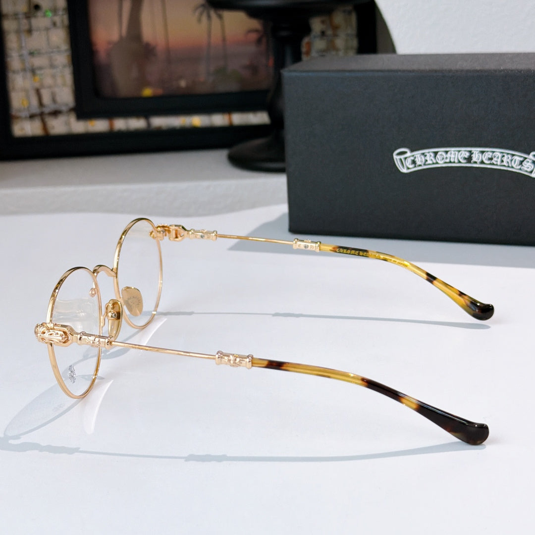 Gold metal eyeglasses with clear lenses and tortoise-pattern temple tips