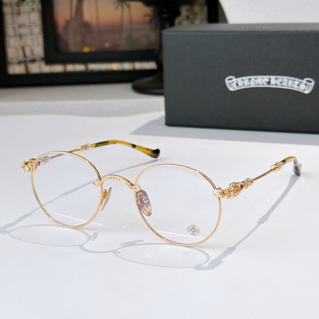 Round metal eyeglasses with clear lenses, gold frame, and tortoise-pattern temple tips