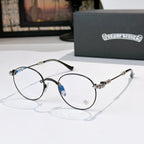 Round metal eyeglasses with clear lenses, dark frame, blue detail, and black temple tips