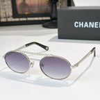 Silver-tone round sunglasses with purple tinted lenses and rhinestone chain temple detail