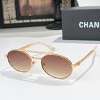 Gold-tone round sunglasses with brown tinted lenses and rhinestone chain temple detail