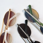Assorted sunglasses with pearl chain strap details and tinted lenses