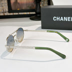 Silver-tone round sunglasses with green temples and rhinestone chain temple detail