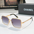 Chanel cat-eye sunglasses with gold-tone frame and purple gradient lenses