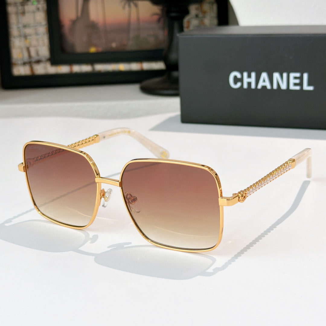 Chanel cat-eye sunglasses with gold-tone frame and warm brown gradient lenses