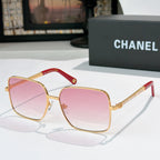 Chanel cat-eye sunglasses with gold-tone frame and pink gradient lenses, red accents