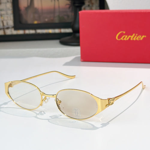Round gold-tone sunglasses with clear lenses and thin metal bridge detail
