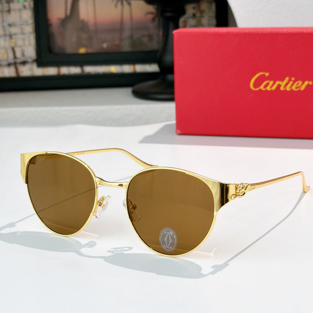 Gold-rimmed round sunglasses with amber-tinted lenses and decorative metal temples
