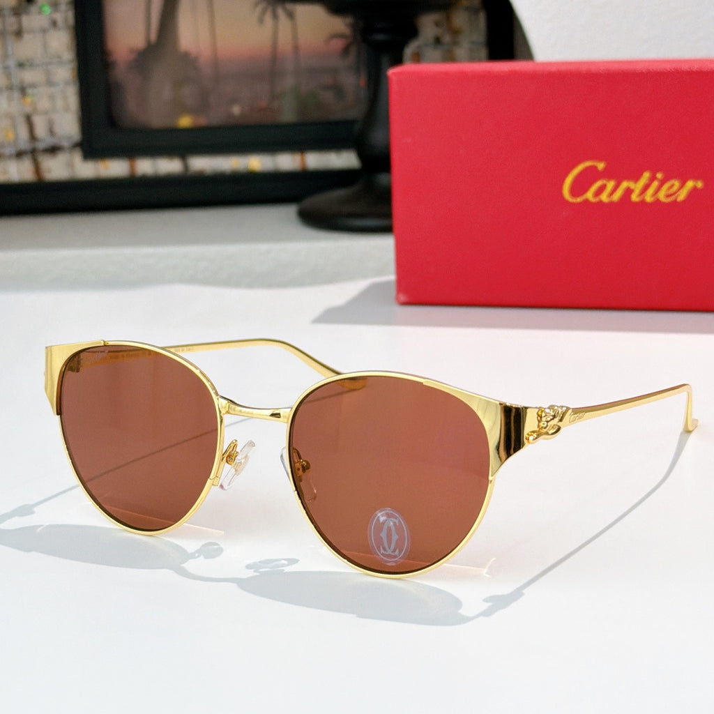 Gold-rimmed round sunglasses with caramel-tinted lenses and decorative metal temples