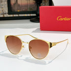 Gold-rimmed round sunglasses with brown-tinted lenses and ornate metal temples