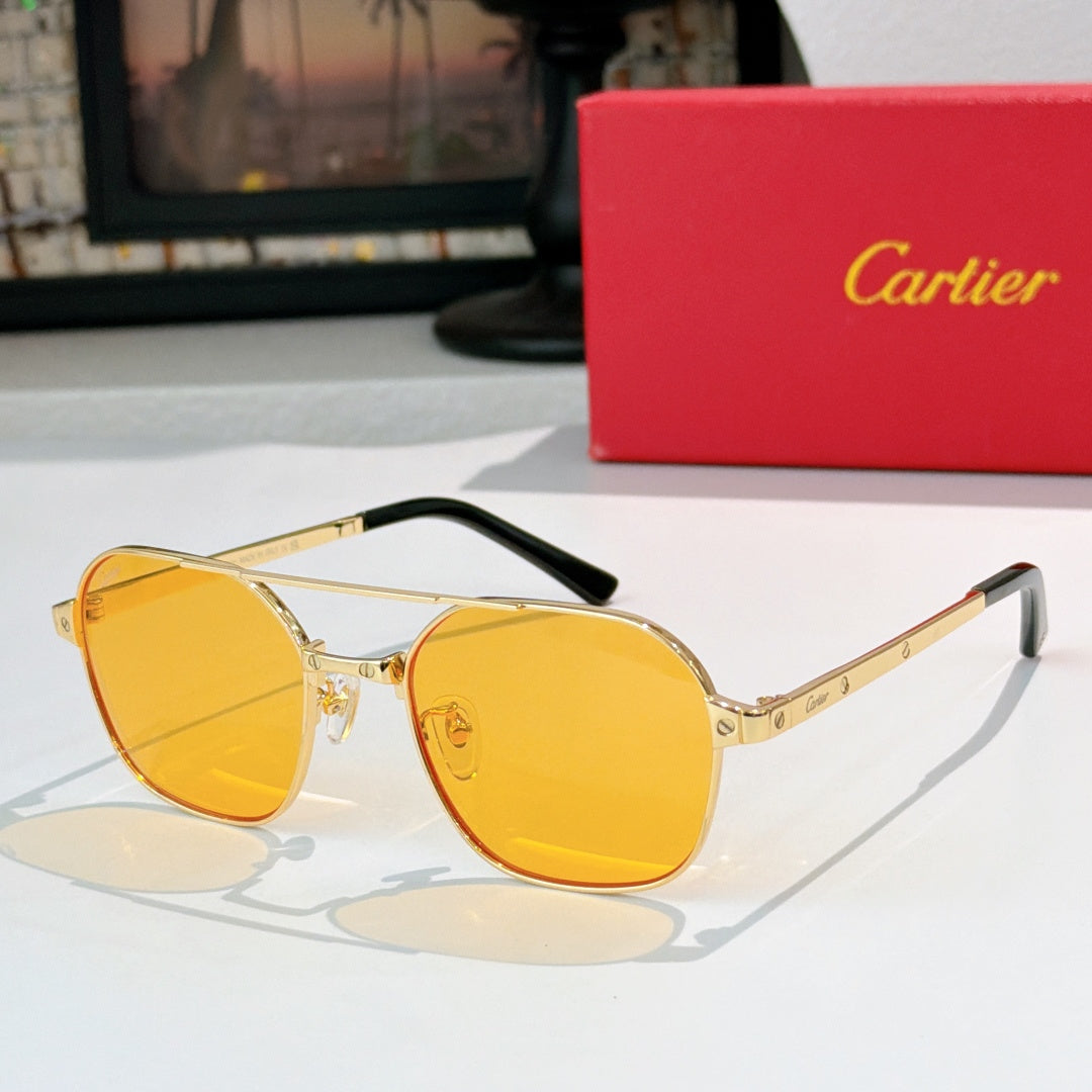 Sunglasses with gold frame, black temples, and amber tinted round lenses