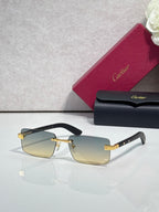 Cartier eyeglasses with black frame and gold-tone hinge, amber tinted lenses, rectangular shape