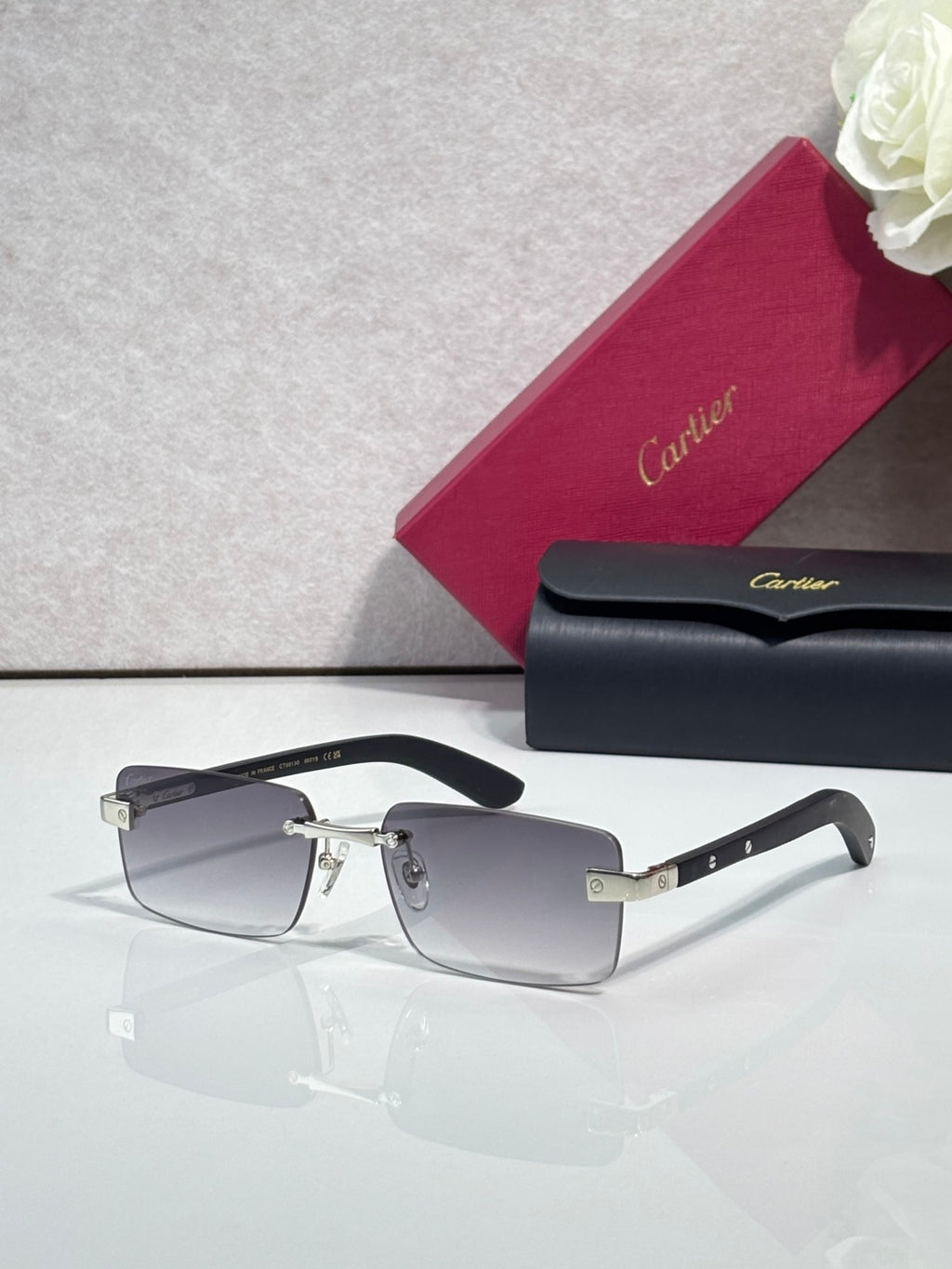 Cartier eyeglasses with black frame and gold-tone hinge, clear lenses, rectangular shape