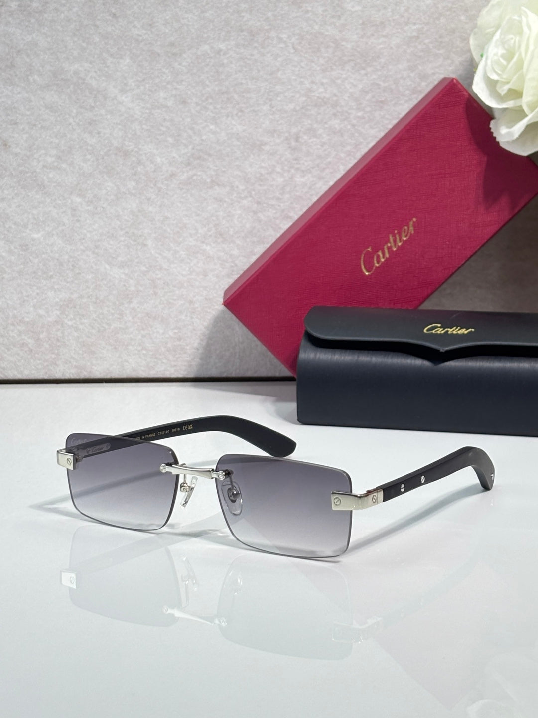 Cartier eyeglasses with black frame and gold-tone hinge, clear lenses, rectangular shape