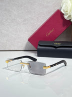 Cartier eyeglasses with black frame and gold-tone hinge, clear lenses, rectangular shape